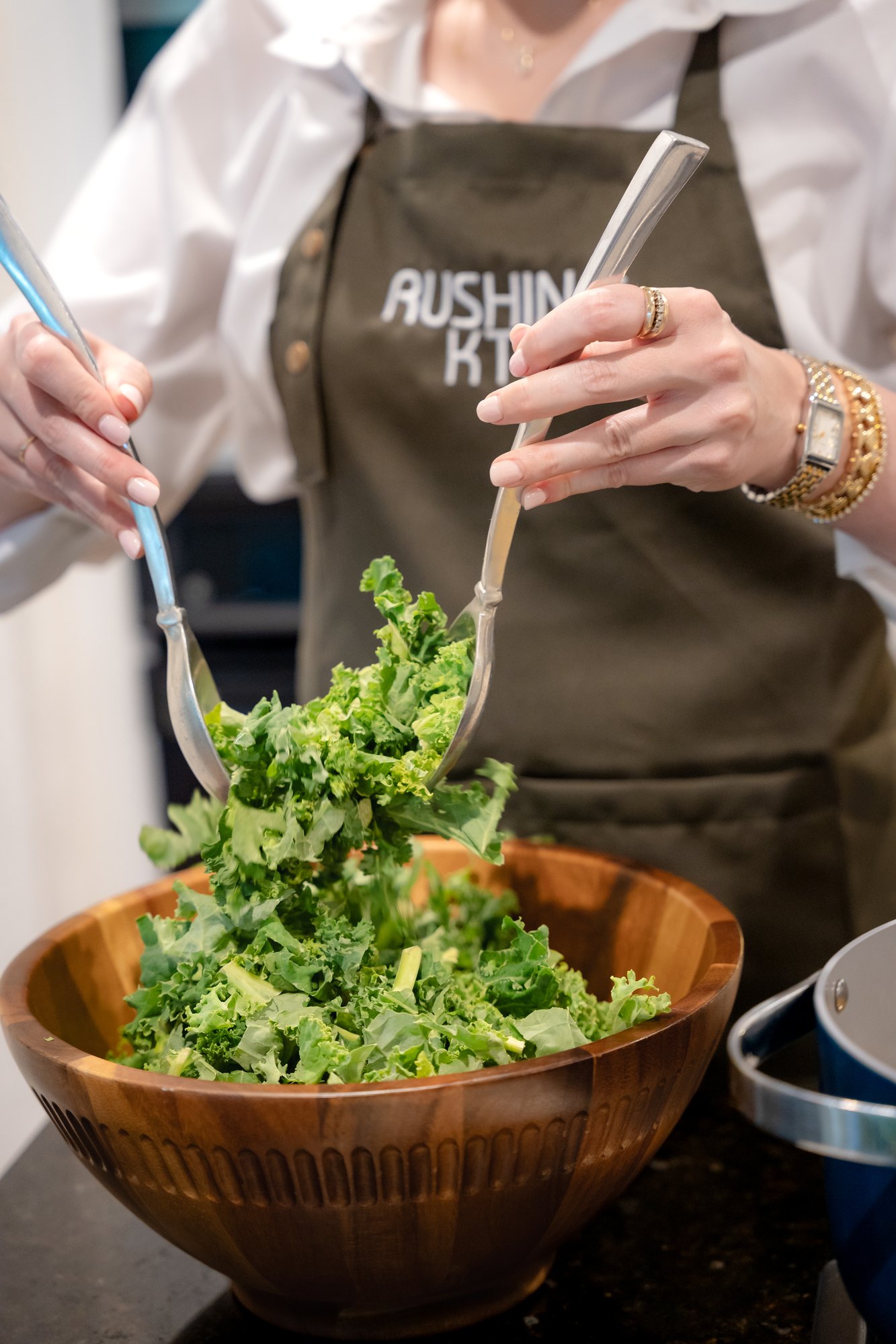 Chef Alex tossing a fresh kale salad